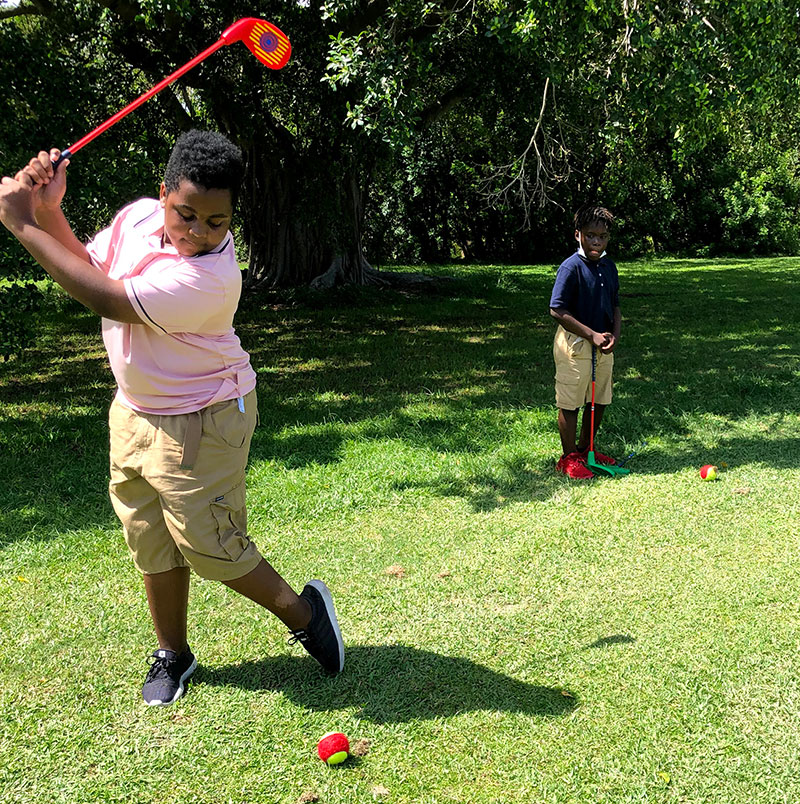 Students practicing golf with First Tee Broward