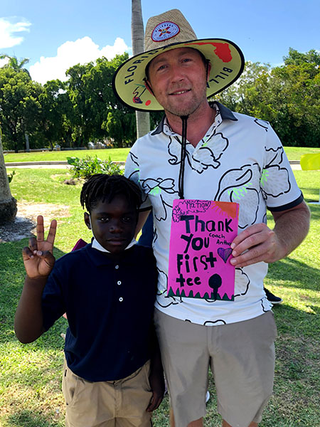 A student thanking a First Tee coach with a handmade card