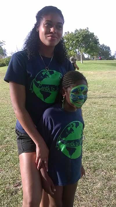 Mentor and student in Earth to Sky shirts with globe face paint