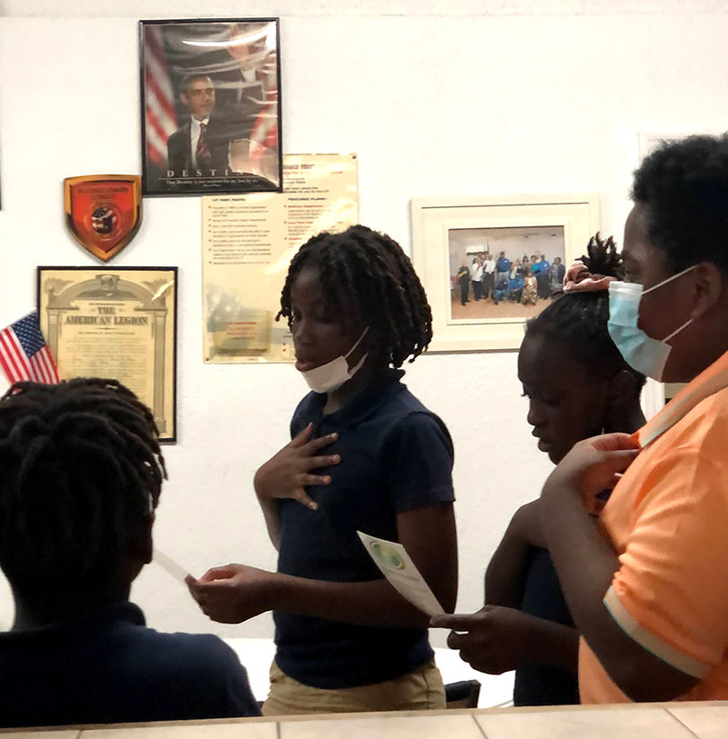 Students reciting a pledge together during an afterschool session